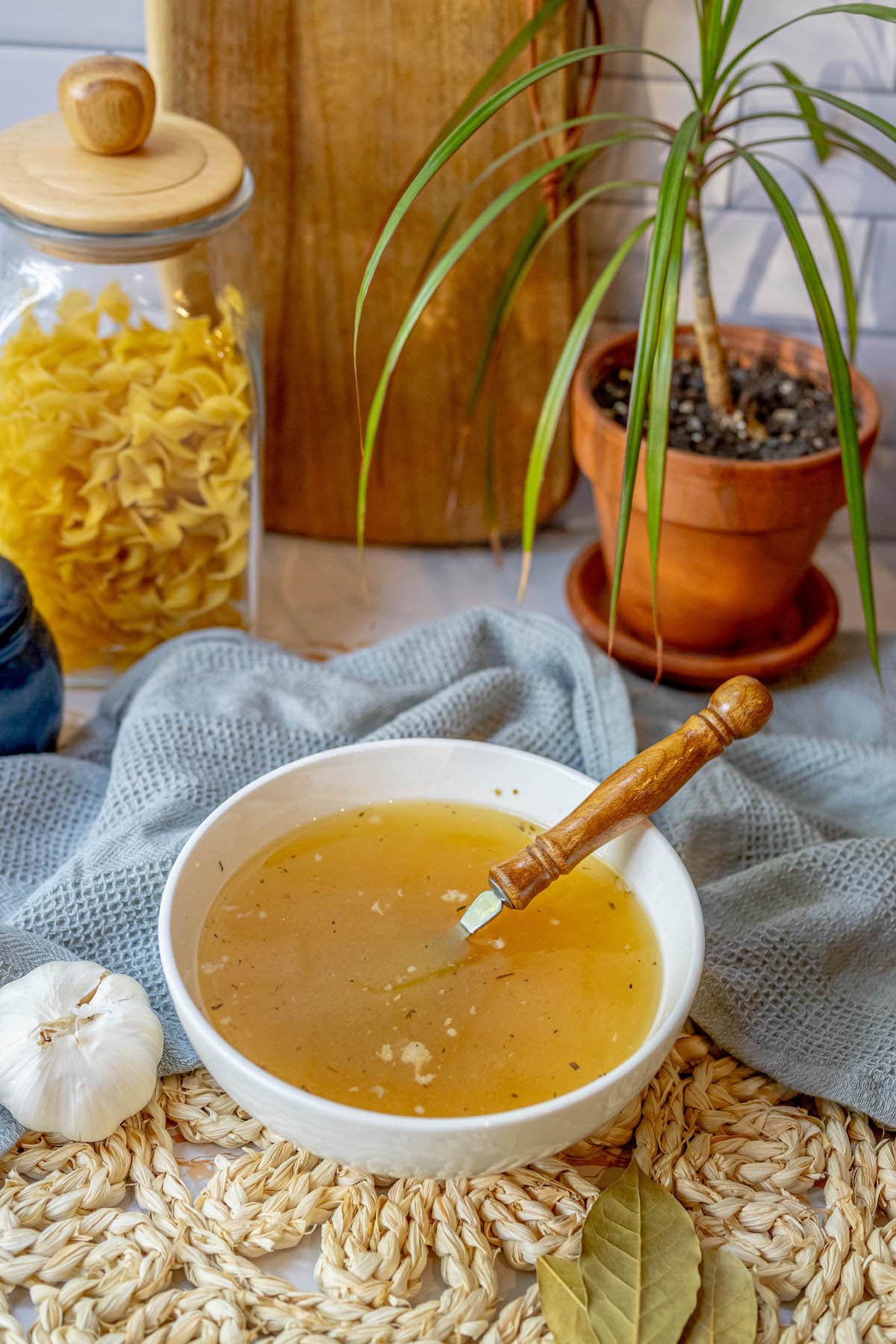 bowl of yellow stock in a bowl with a spoon in it