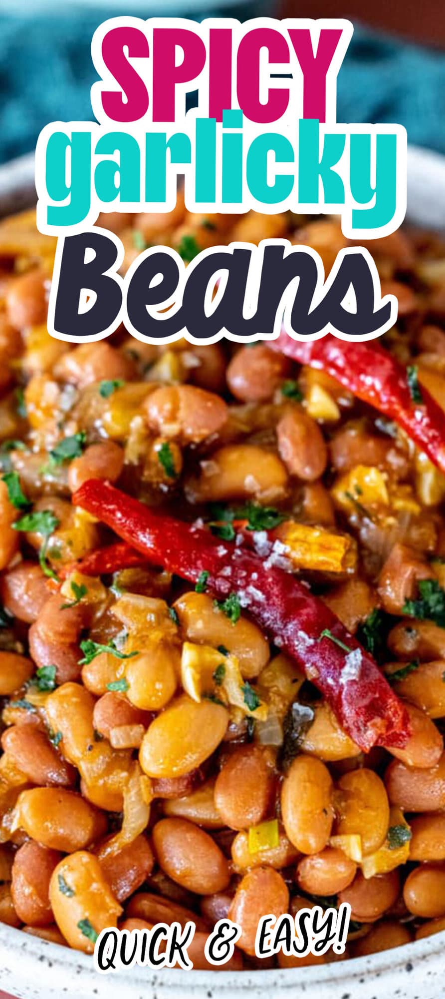 spicy beans in a bowl with salt, cilantro, and chilies on top
