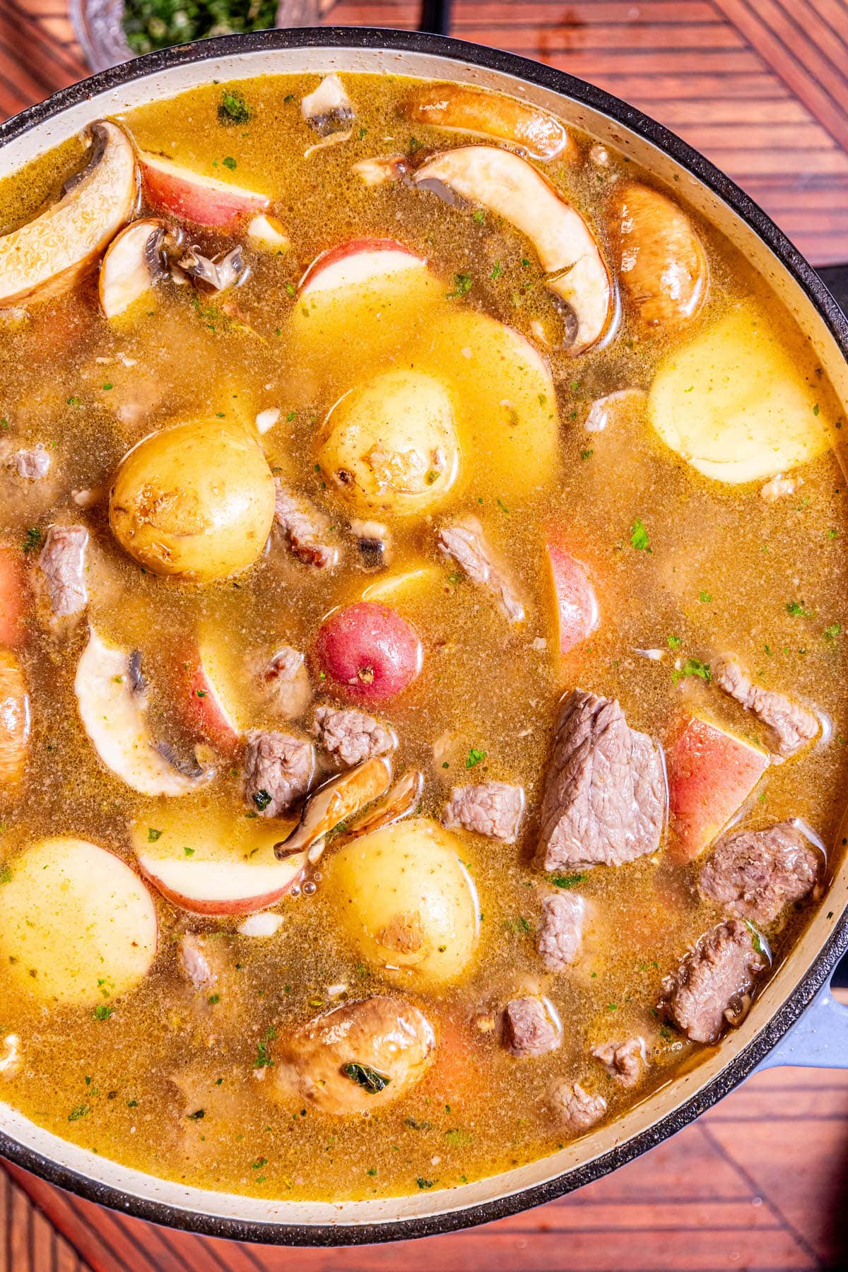 stew meat, carrots, potatoes, and minced parsley in a bowl