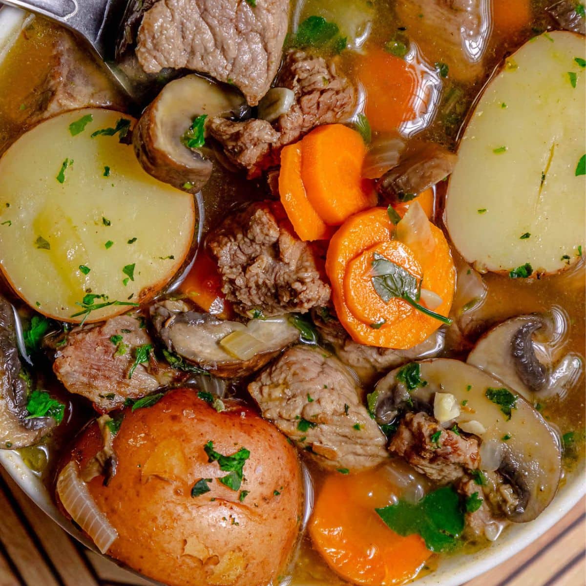 A hearty beef stew with tender steak, potatoes, and carrots cooked in flavorful IPA beer.