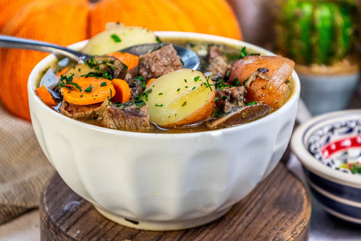 stew meat, carrots, potatoes, and minced parsley in a bowl