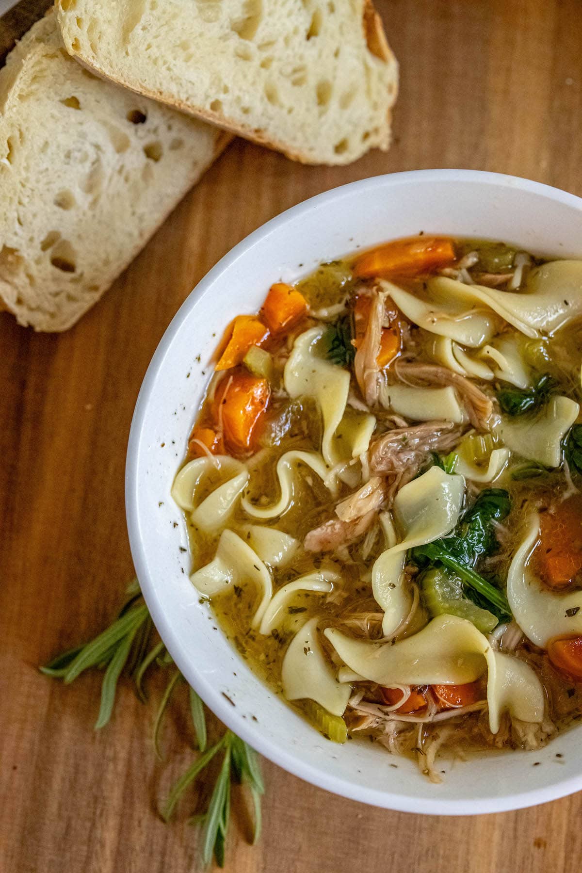 egg noodles, turkey, spinach, carrots, celery, and stock in a bowl