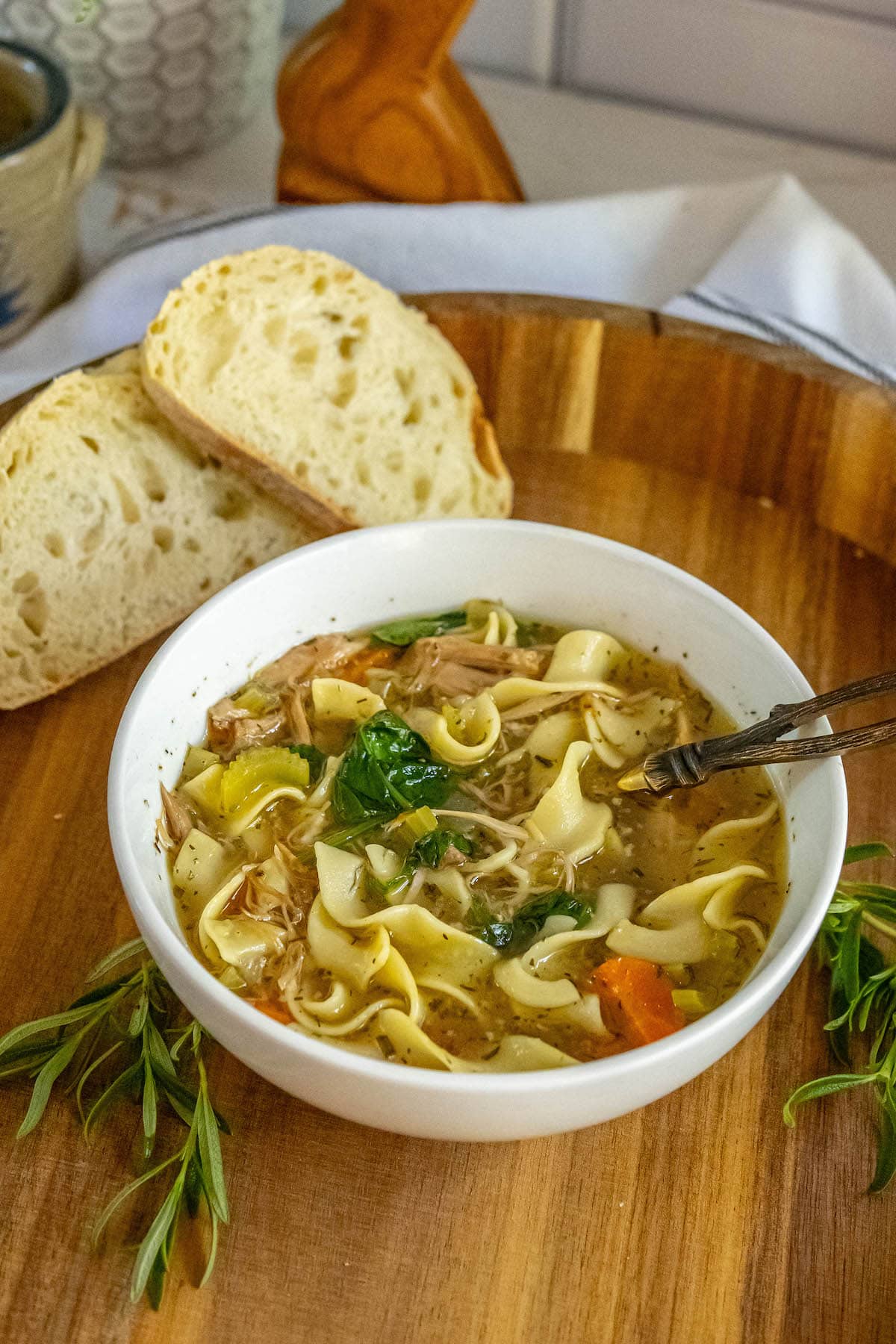 egg noodles, turkey, spinach, carrots, celery, and stock in a bowl