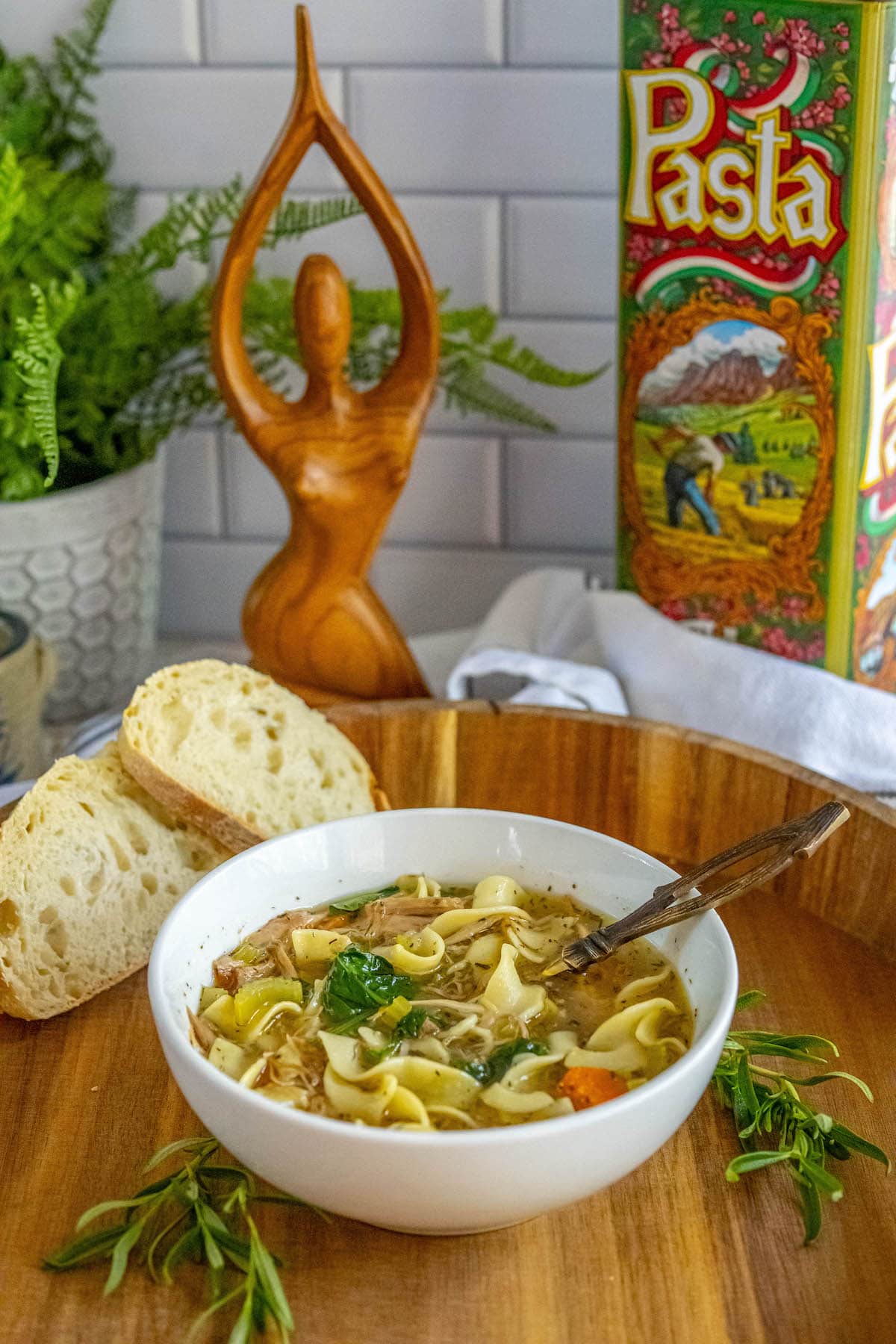 egg noodles, turkey, spinach, carrots, celery, and stock in a bowl