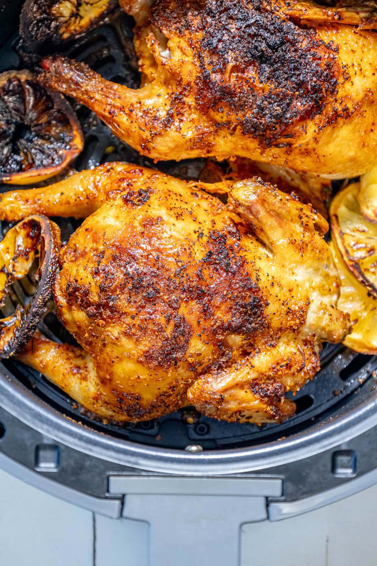 air fried cornish game hens seasoned with herbs in an air fryer basket