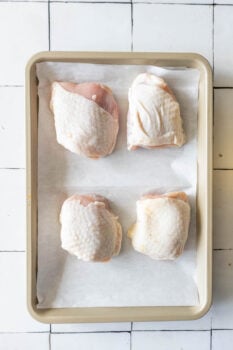 Baked chicken breasts on a tiled floor.