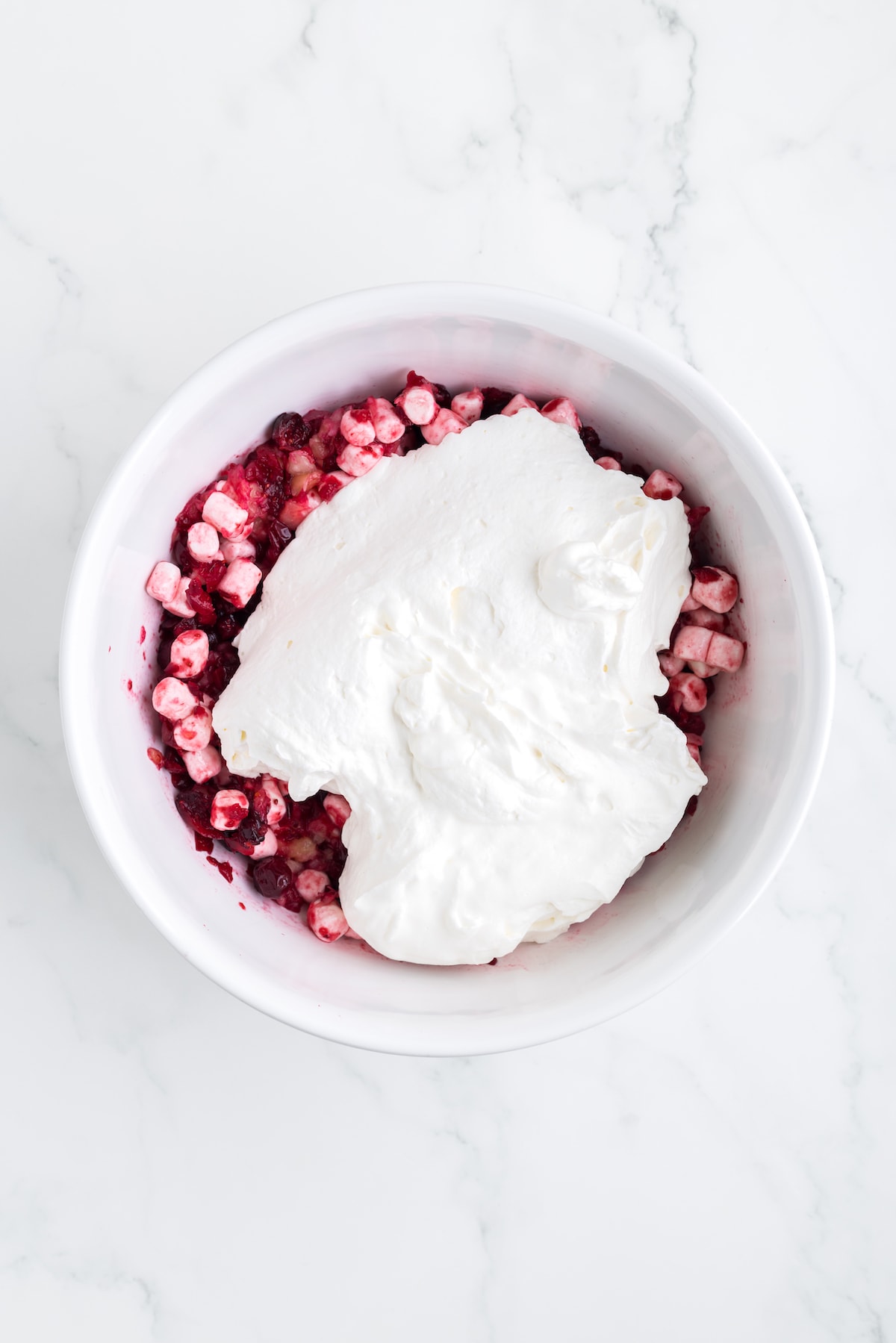 whipped cream on top of cranberry marshmallow mixture