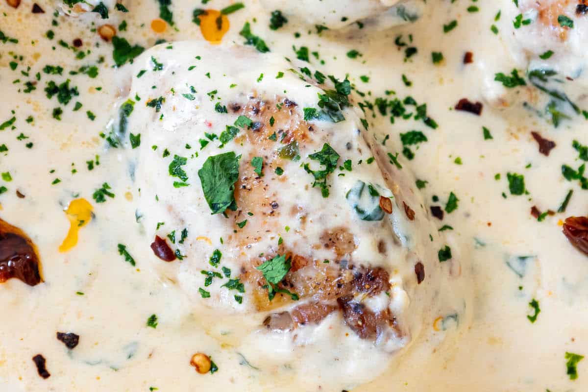 Creamy tuscan chicken with chicken breasts in a creamy sauce.