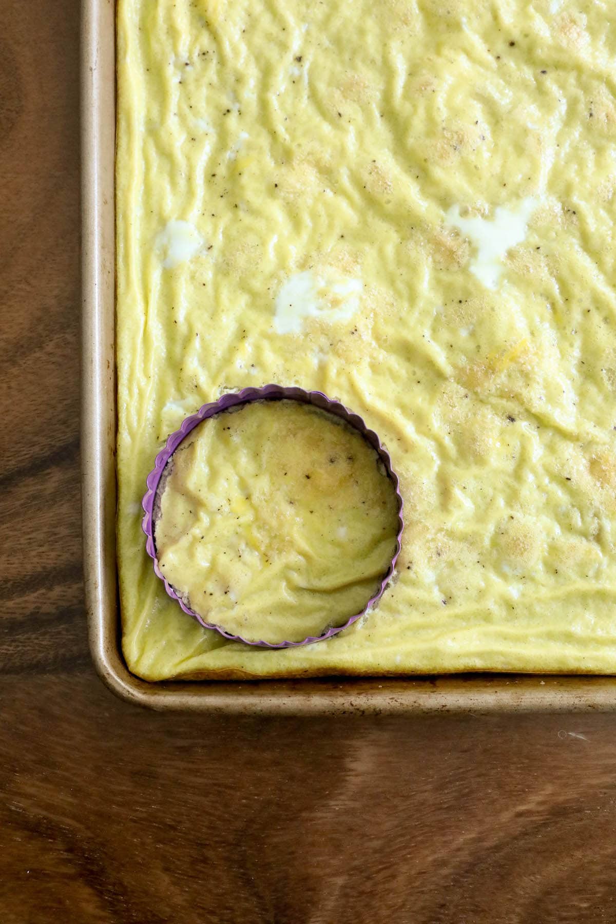 cooked egg in a baking pan with a circle cutter in it