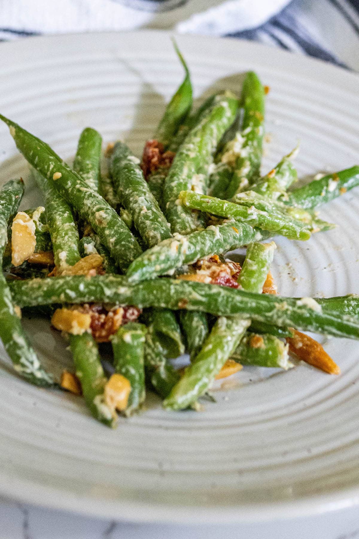 Cheesy green beans with nuts and tomatoes