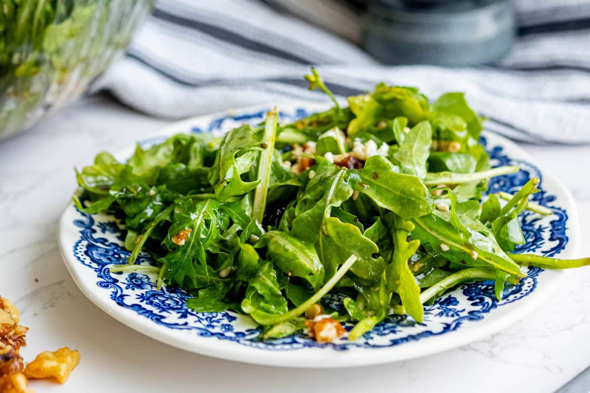 A cranberry salad with arugula and walnuts.