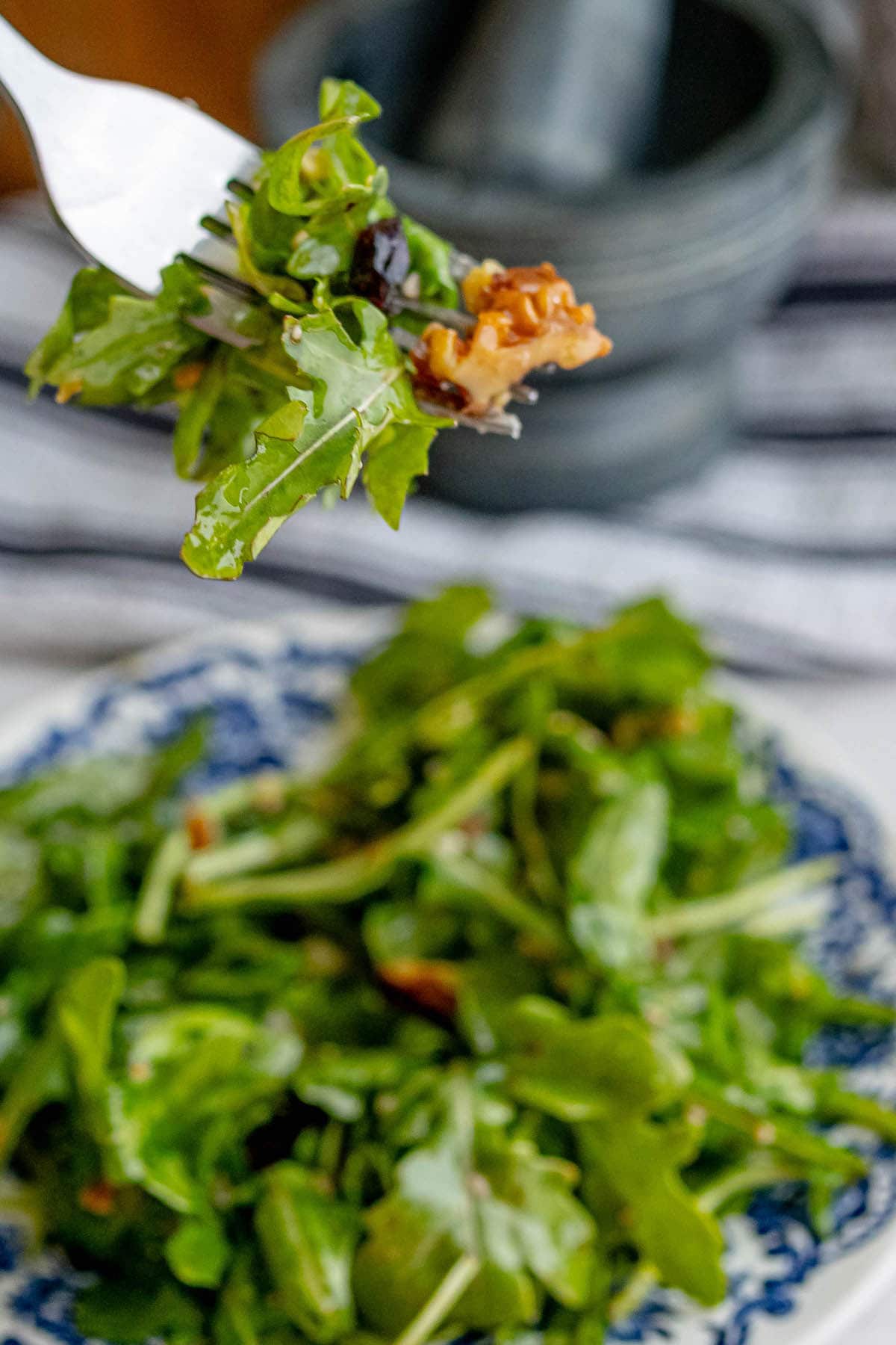 A plate of arugula and walnut salad.