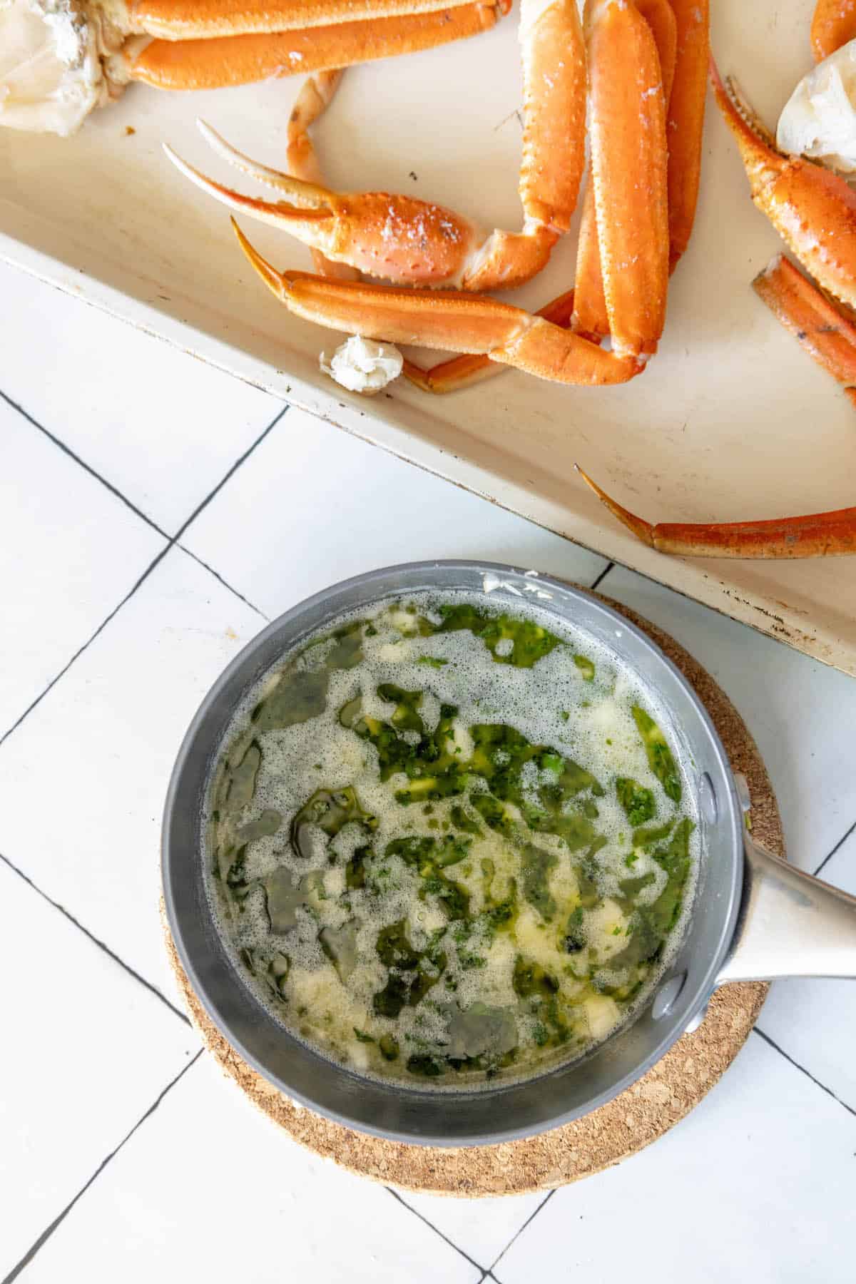 Crabs in a bowl with a sauce on top, baked with snow crab legs.