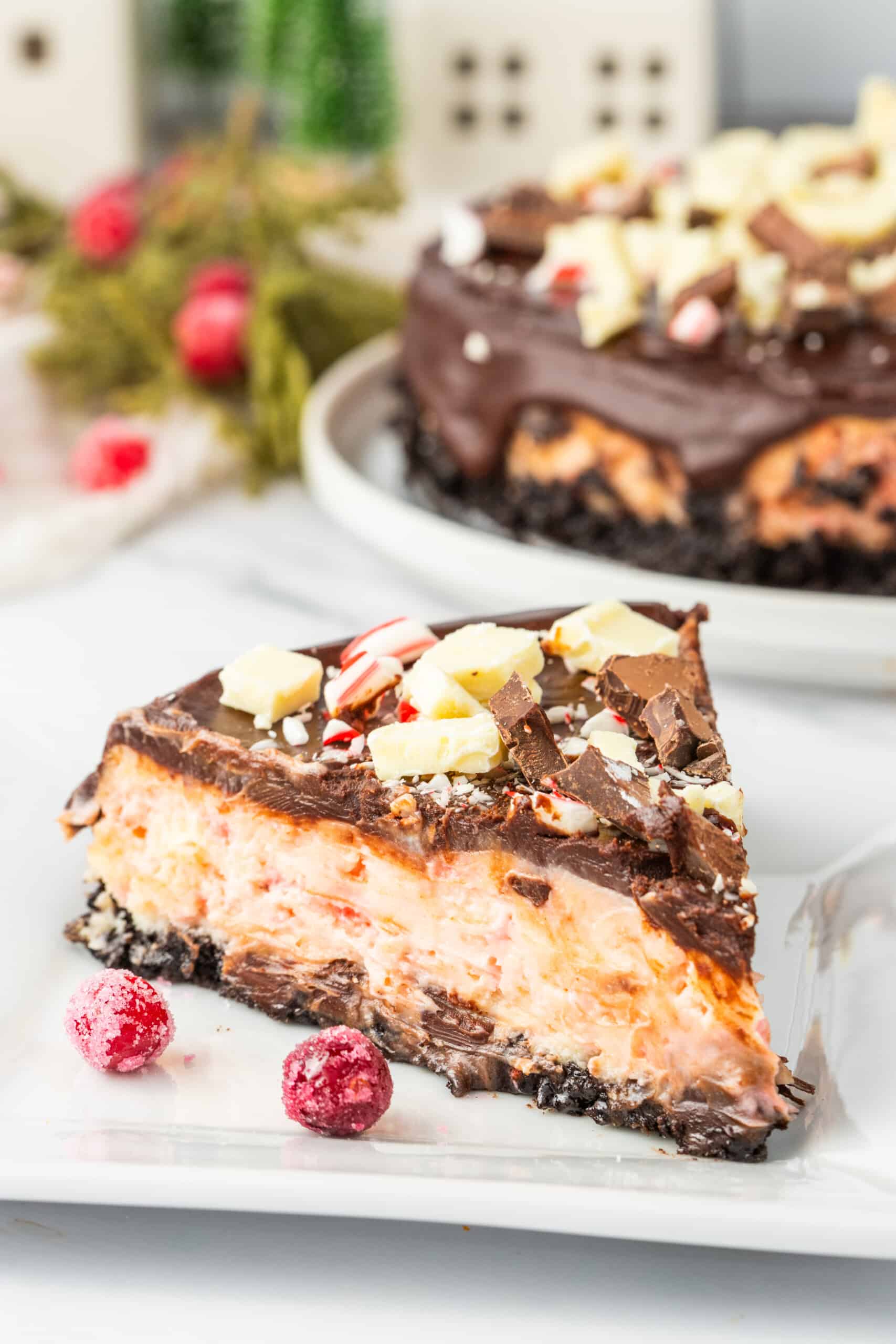 A slice of chocolate peppermint cheesecake on a plate.