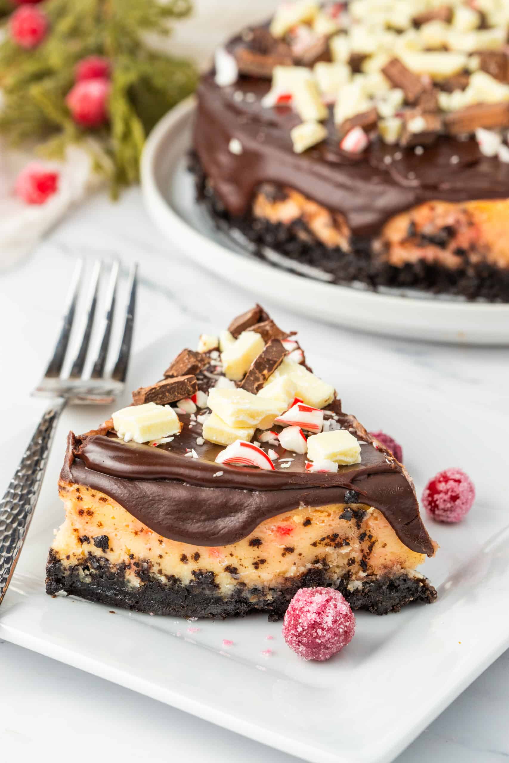 A slice of chocolate peppermint cheesecake on a plate.