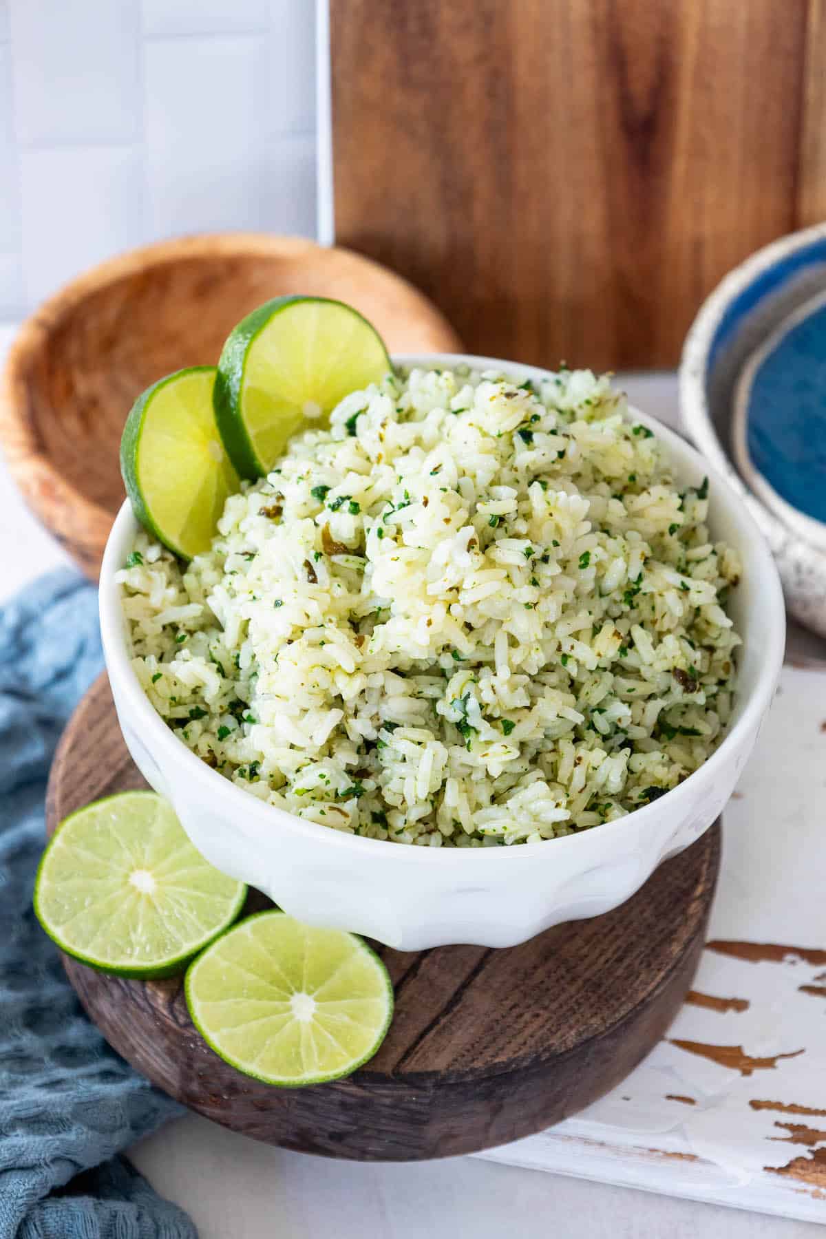 Cilantro lime rice in a white bowl with lime slices.