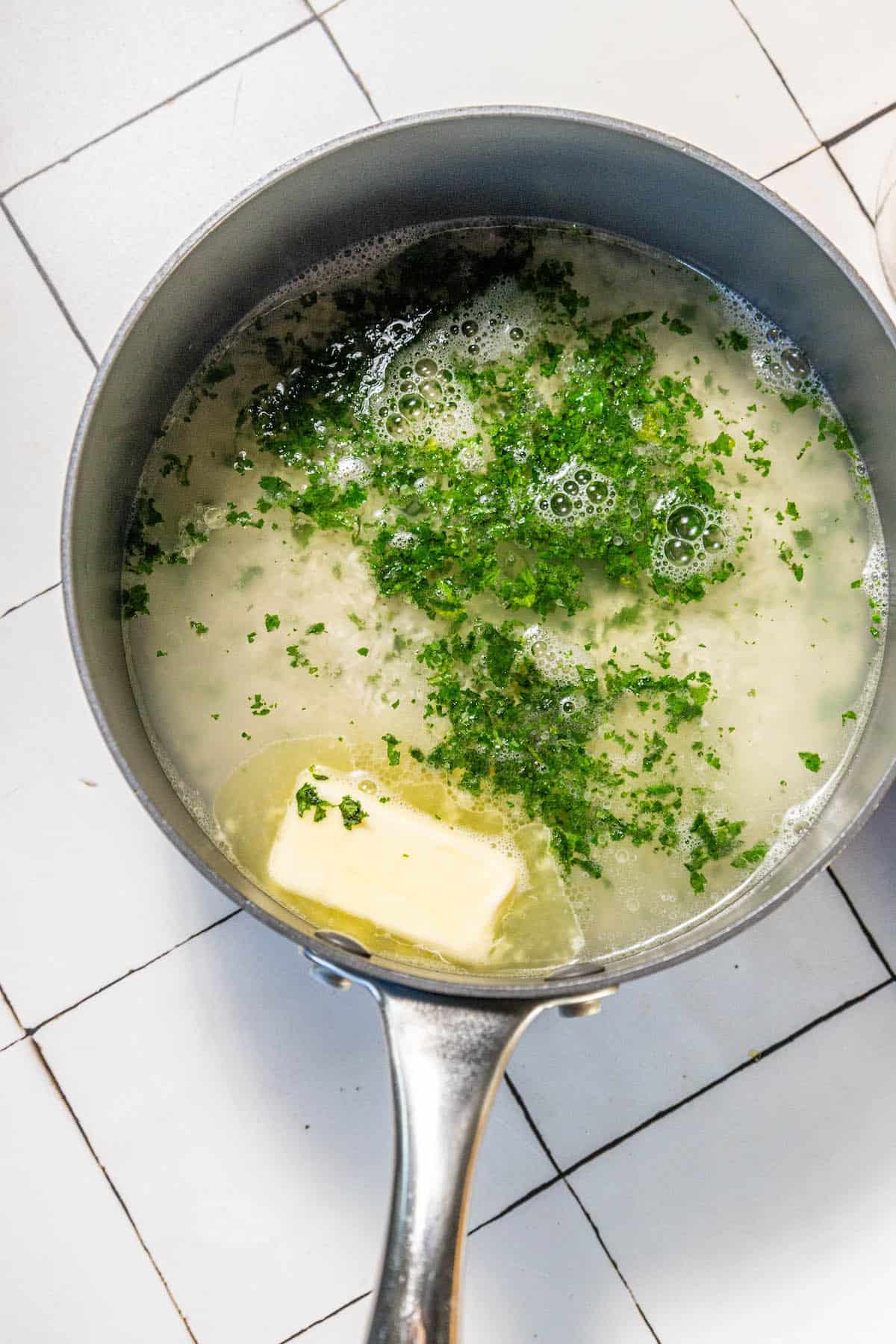 A frying pan with herbs in it.