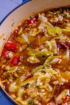 A pot of cabbage soup with meat and vegetables in it.