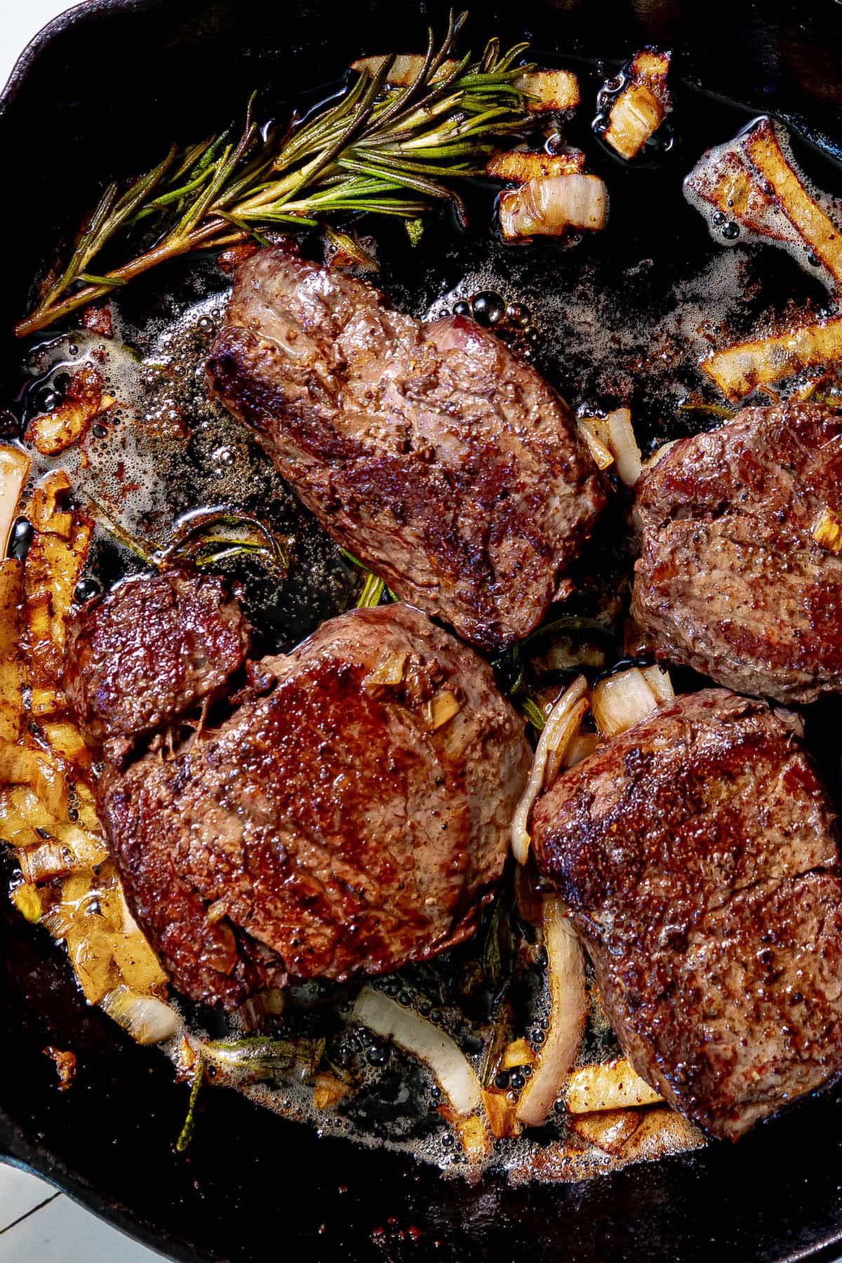 A reverse sear filet mignon cooked in a cast iron skillet.
