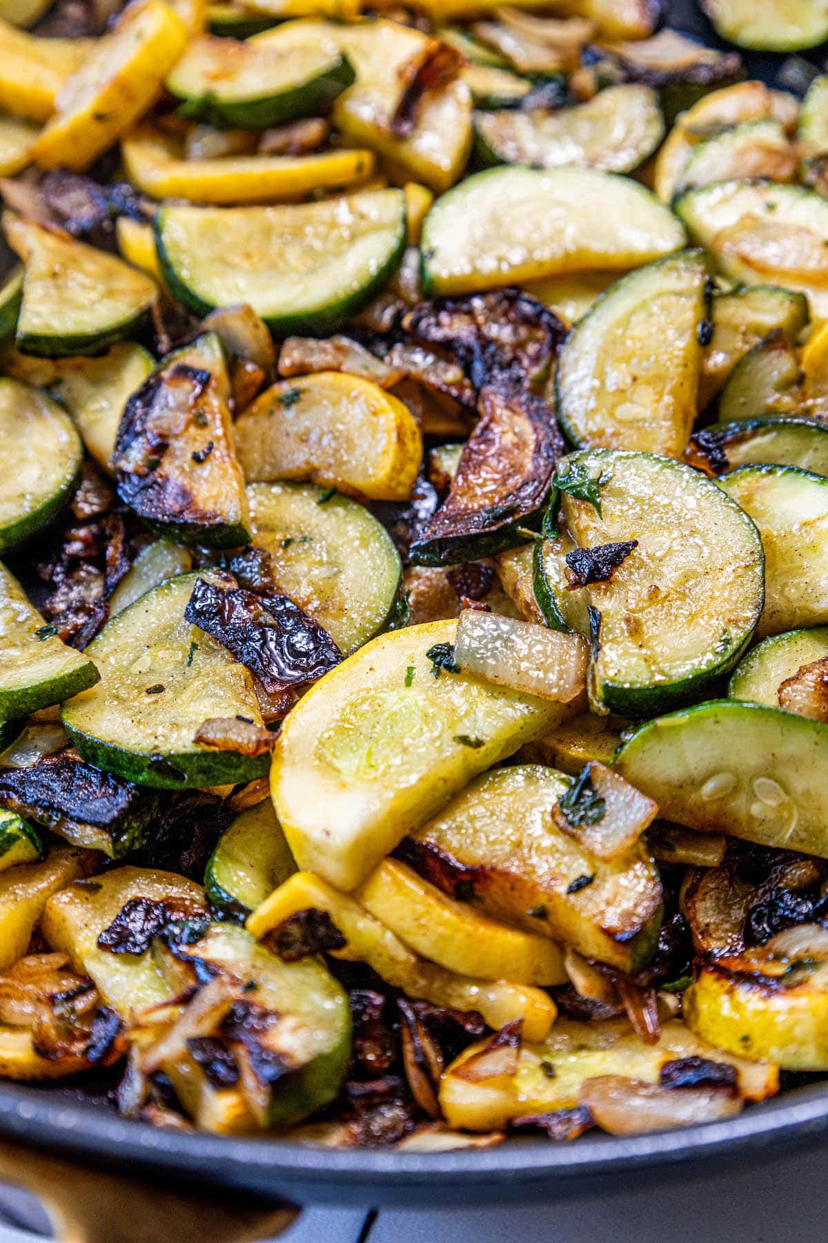A keto recipe for pan fried zucchini and squash, served as a side dish.