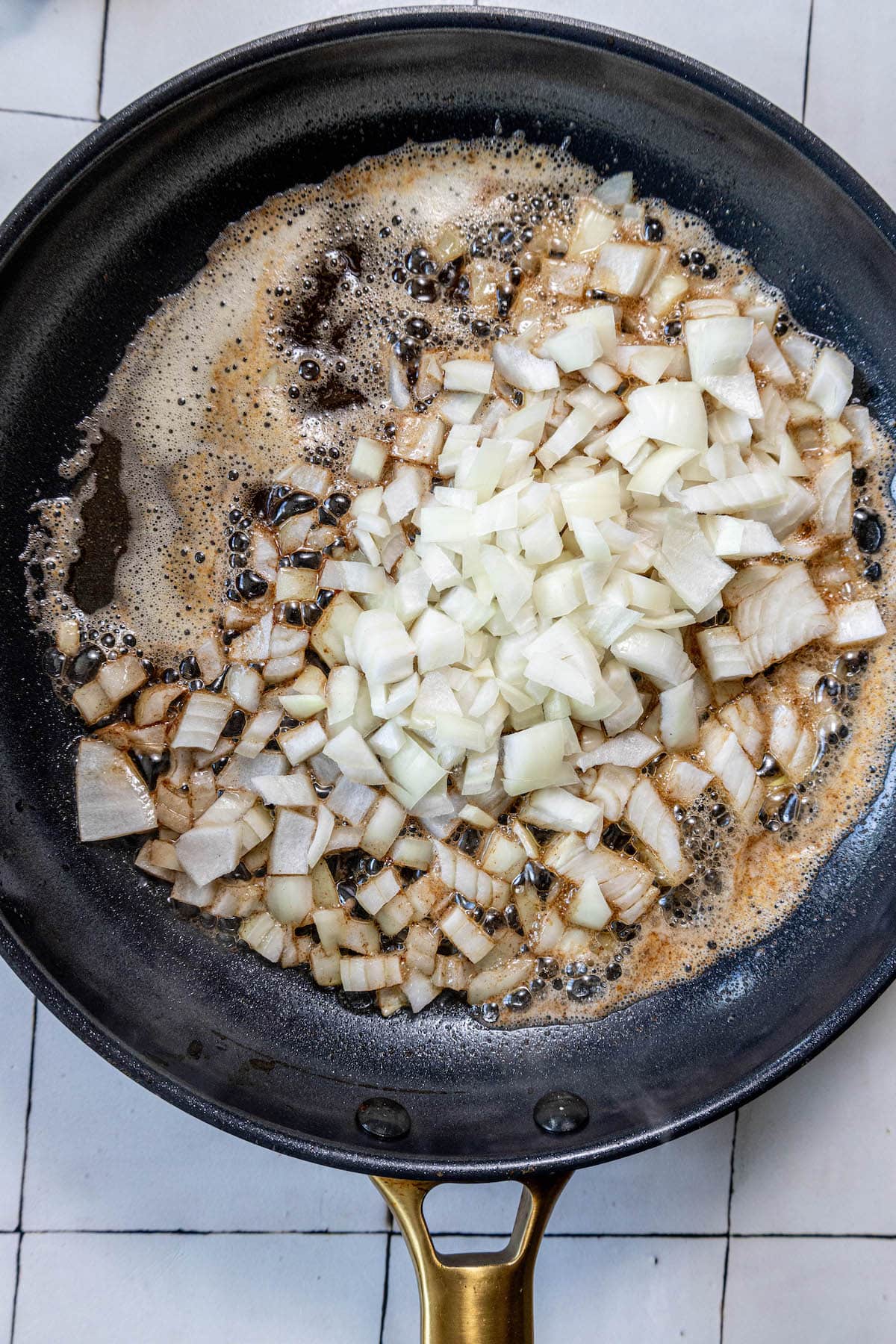 An easy side dish recipe for sautéed zucchini and squash, cooked in a frying pan with onions.
