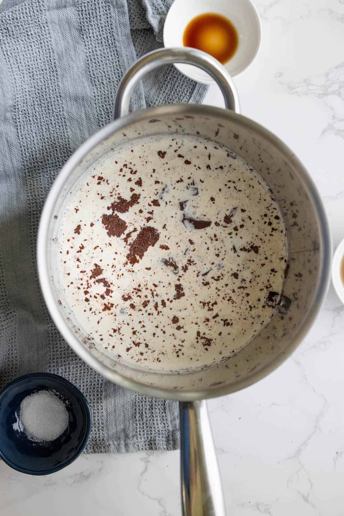 A silky chocolate dessert with a spoon on a table.