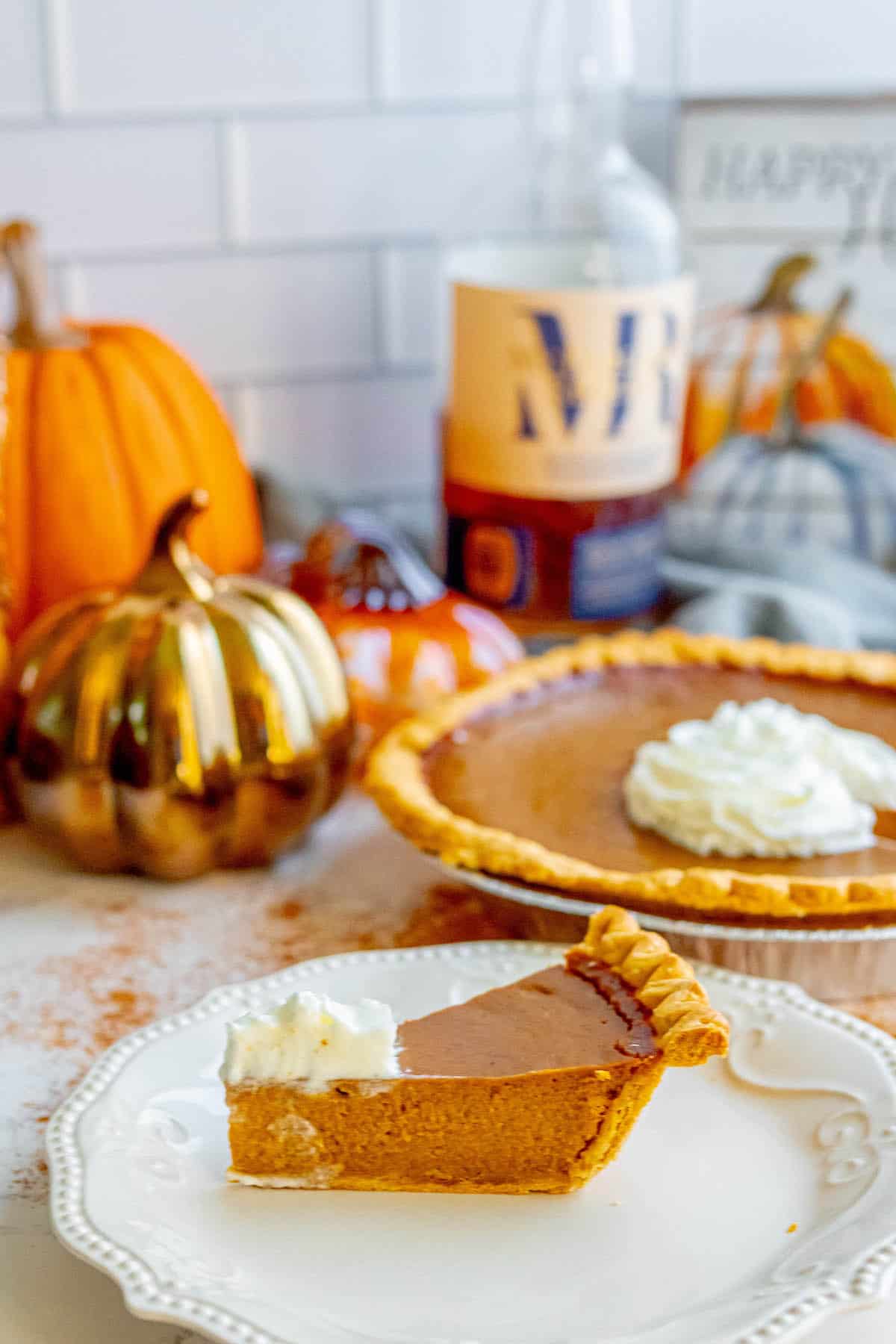 A slice of spicy pumpkin pie plated with bourbon.