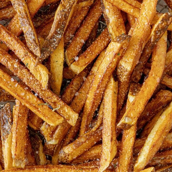 A pile of French fries on a baking sheet.