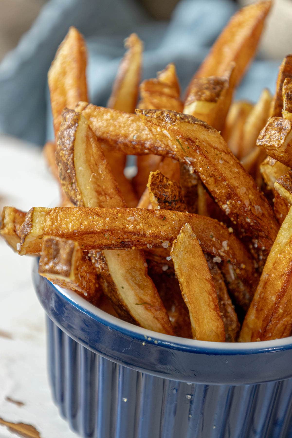 French fries in a bowl on a table.