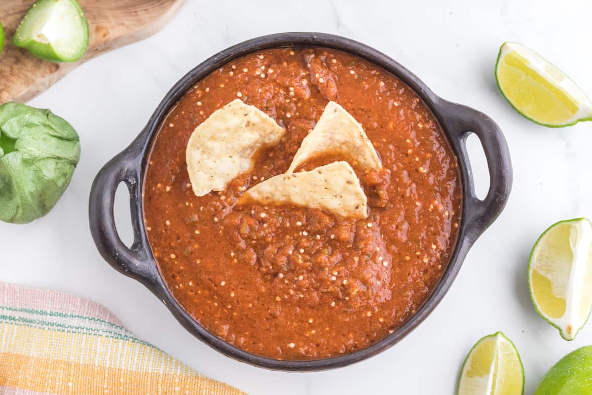 A bowl of Chipotle salsa with tortilla chips.