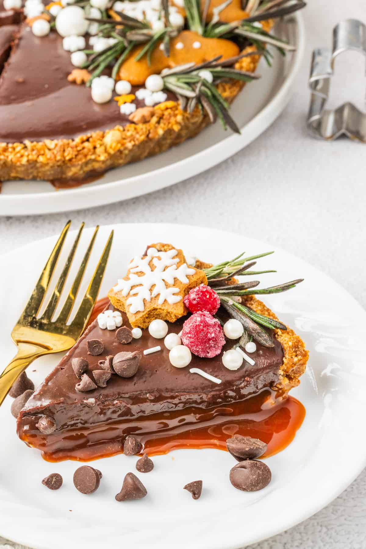 A slice of chocolate caramel pie is sitting on a plate.