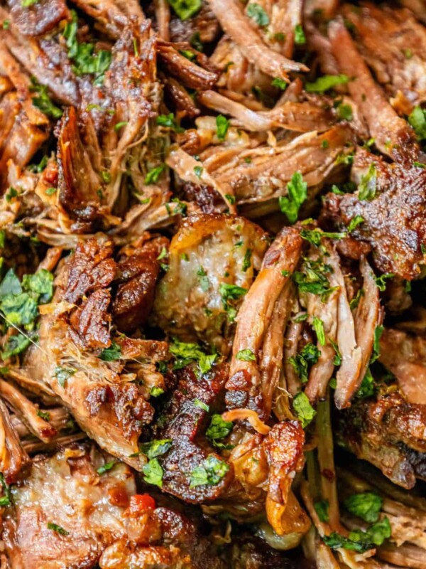 A plate of pulled pork with herbs and parsley, made with a perfect chuck roast.