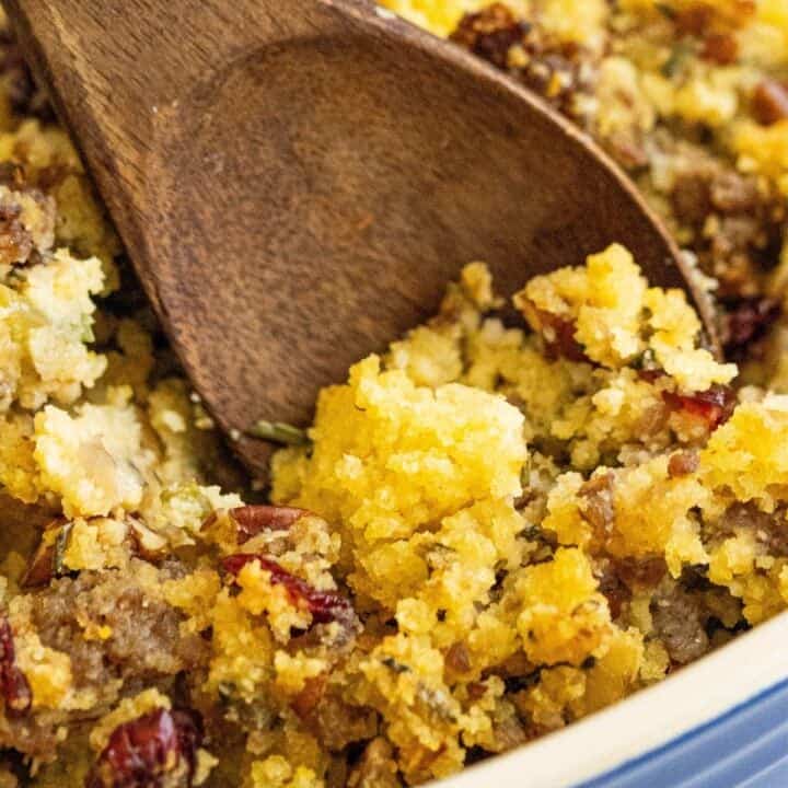 A bowl of cornbread stuffing with sausage.