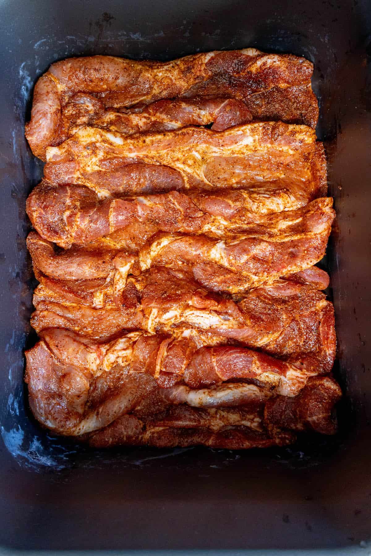 Easy Slow Cooker Pork Steaks Recipe in a baking pan.