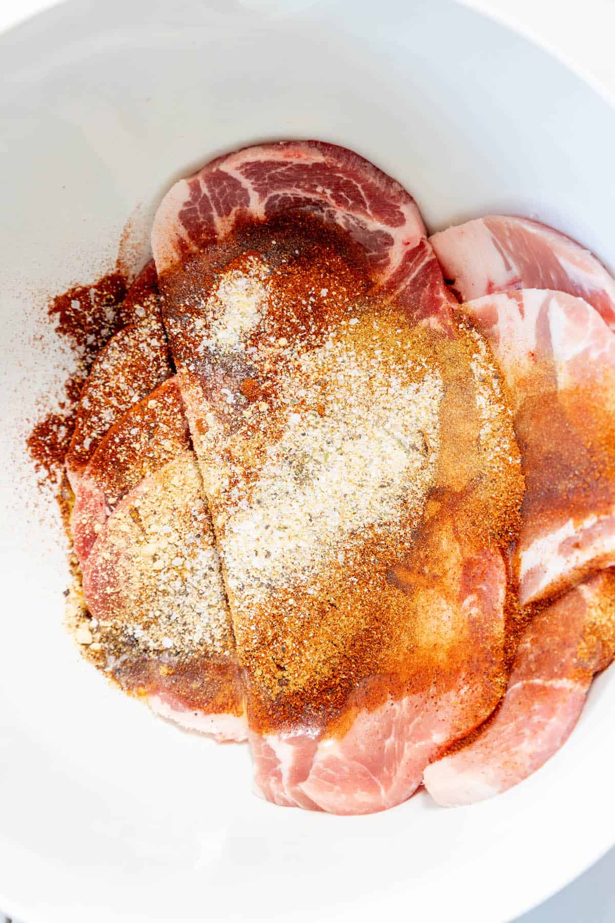 Tender pork steak, seasoned with salt and pepper, simmered in a slow cooker for maximum flavor.
