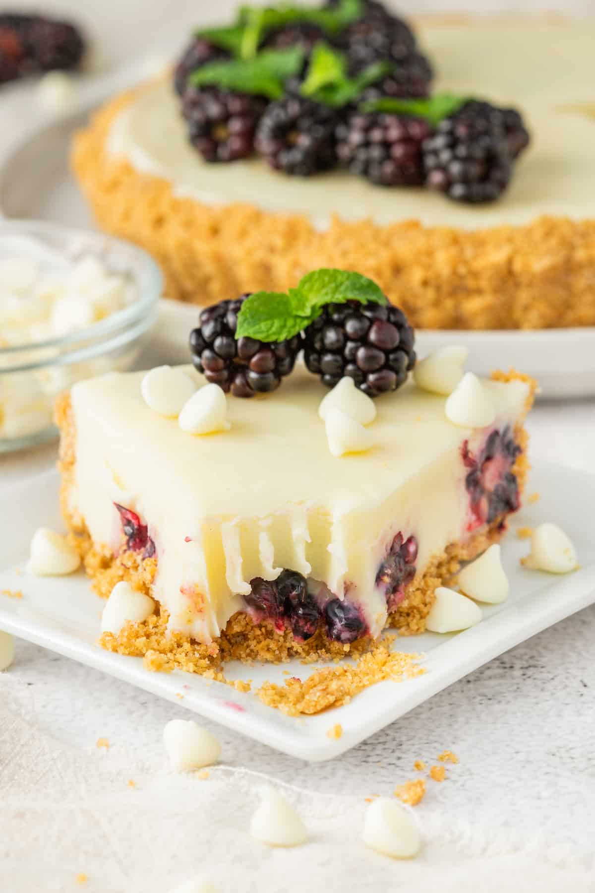 A slice of blackberry cheesecake on a plate.