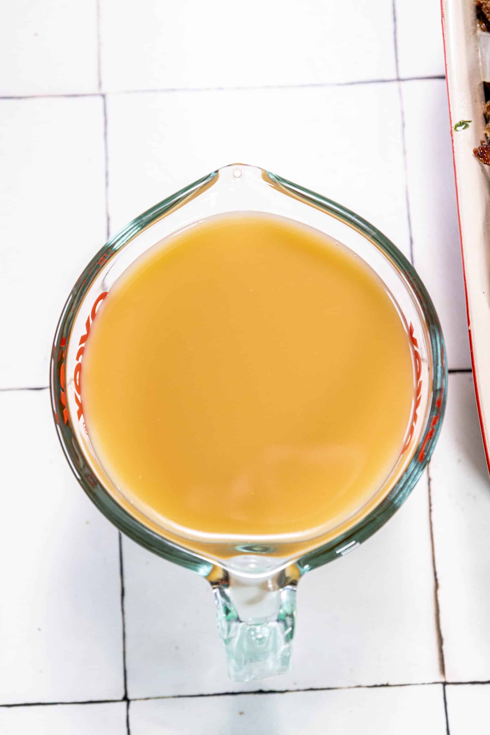 A plate of meat with a side of sauce.