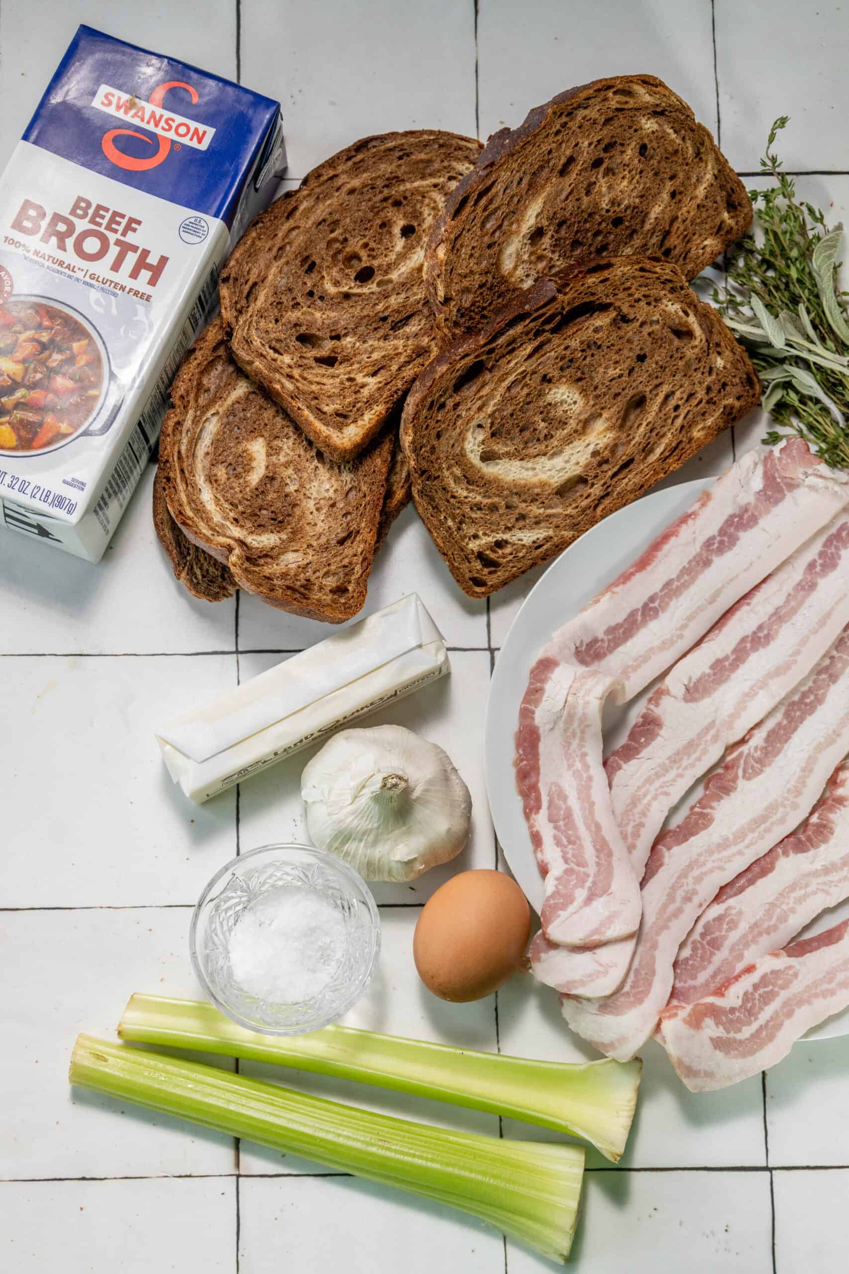 Bacon and bread on a tiled floor.