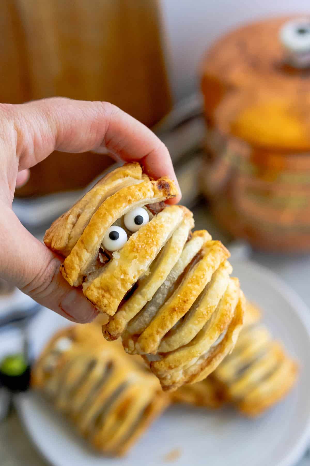 A person is holding a banana mummy.