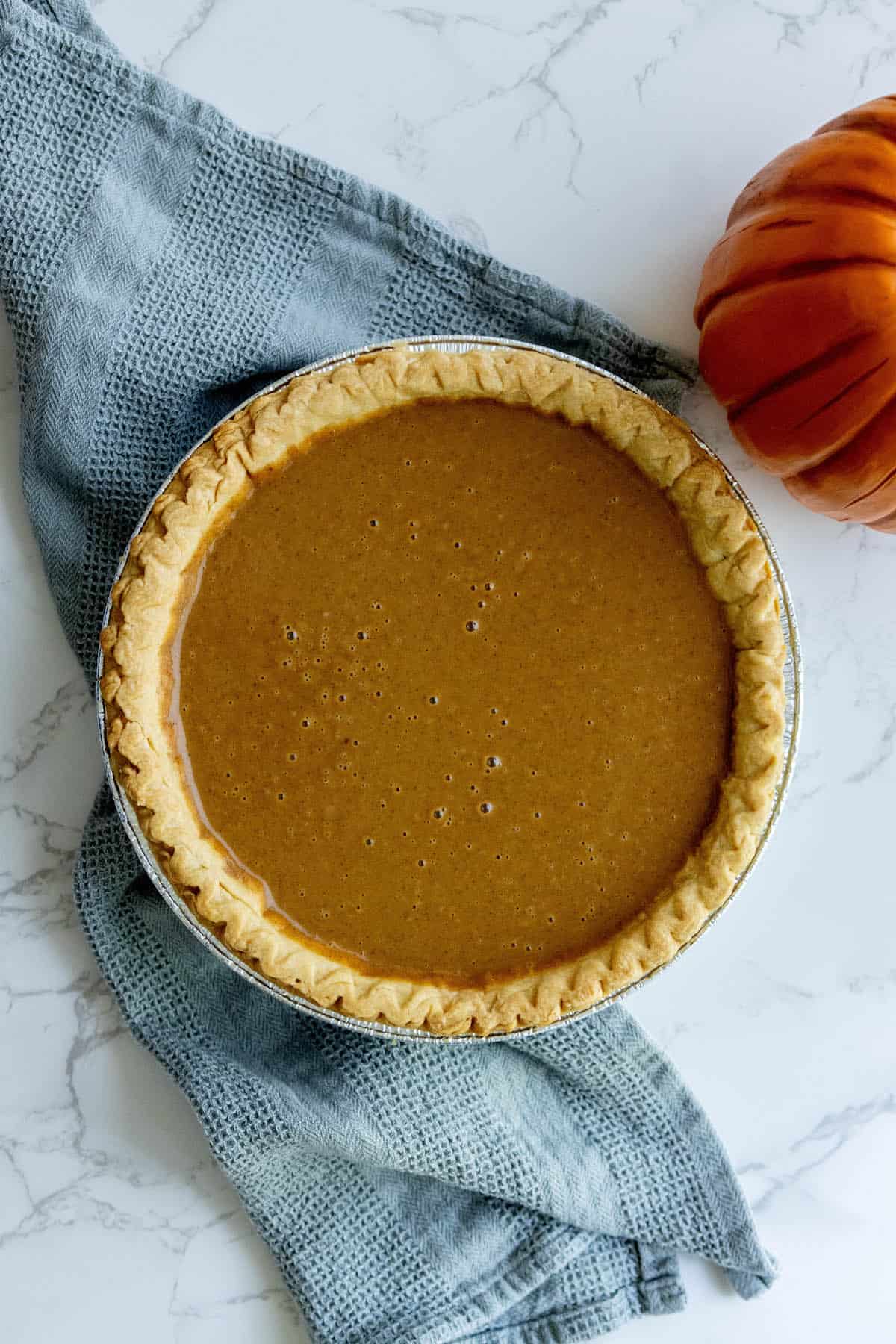 A pumpkin pie is sitting on a table.