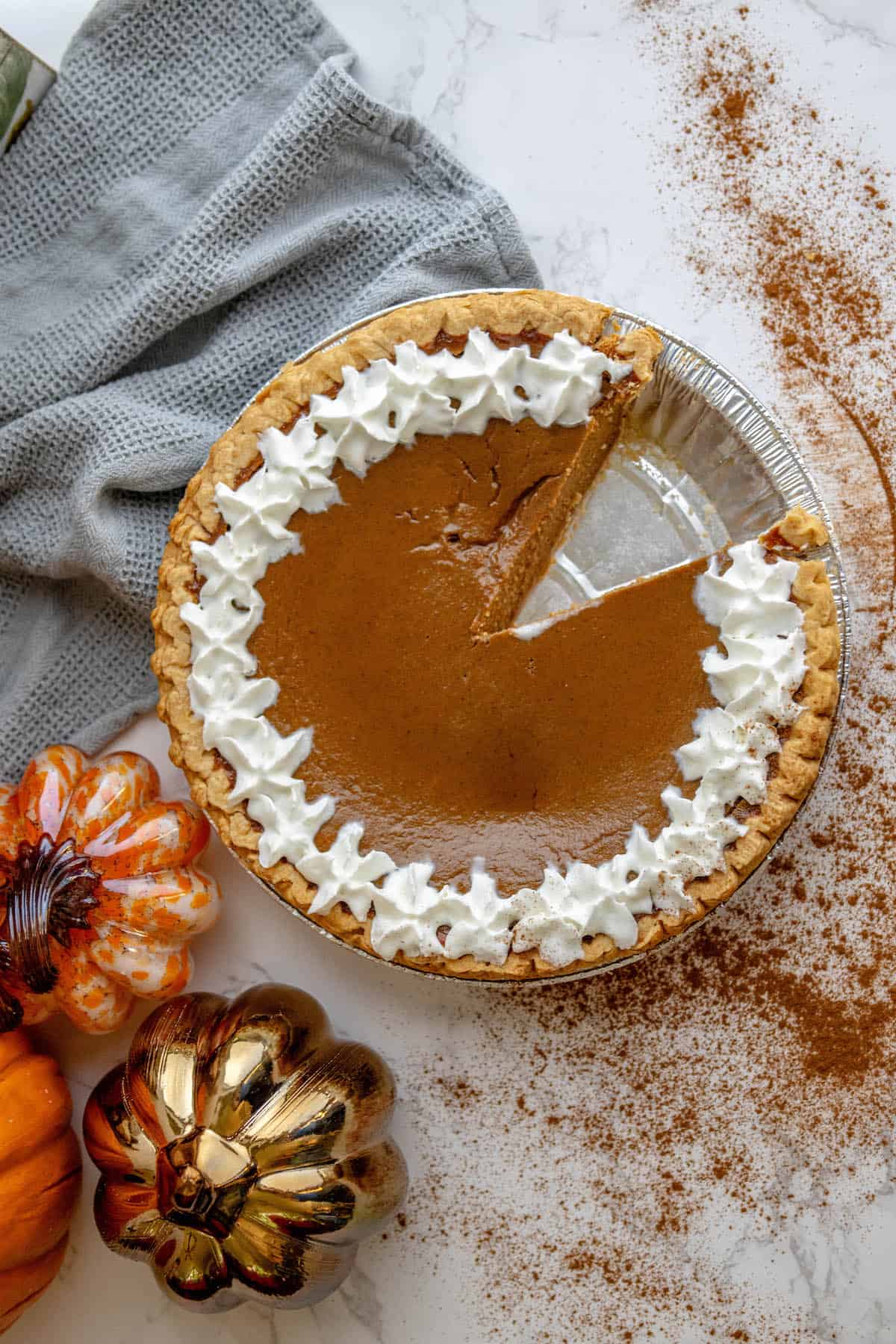 A slice of pumpkin pie with whipped cream.