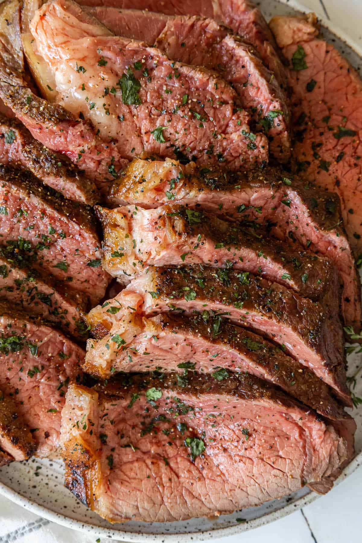 Steak on a plate with herb butter.