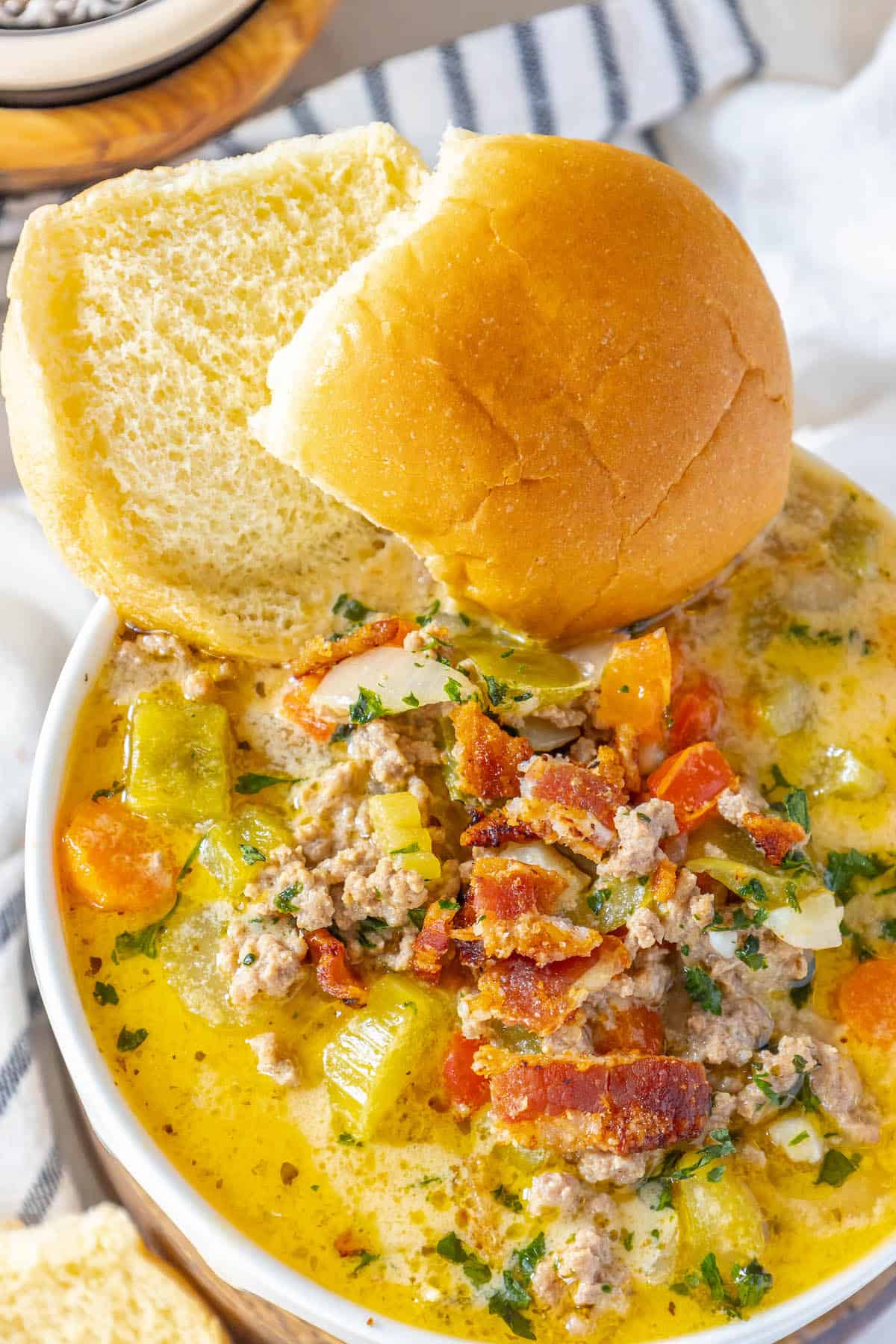 A bowl of Keto Cheeseburger Soup topped with bread.