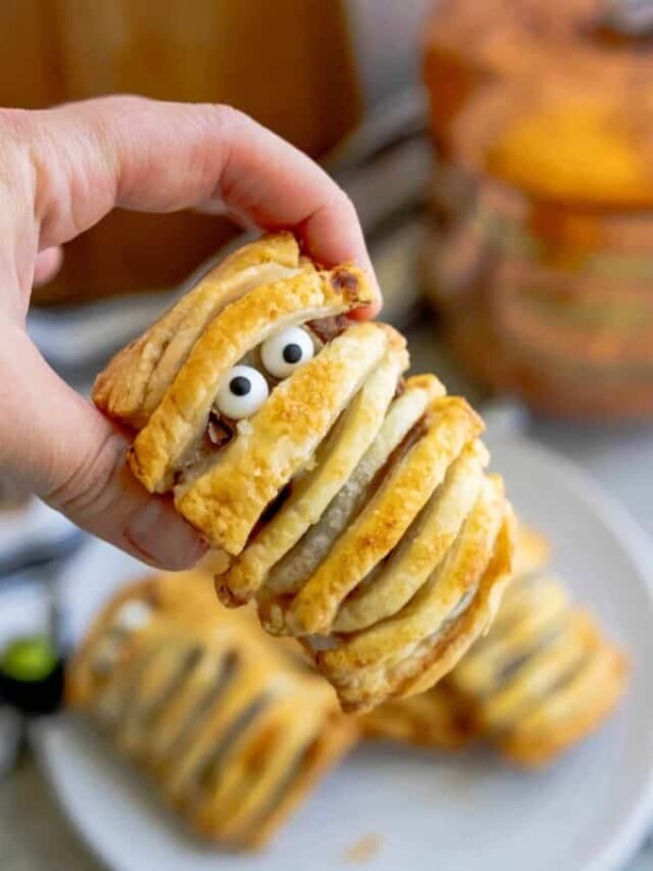 A person holding up a mummy pastry.