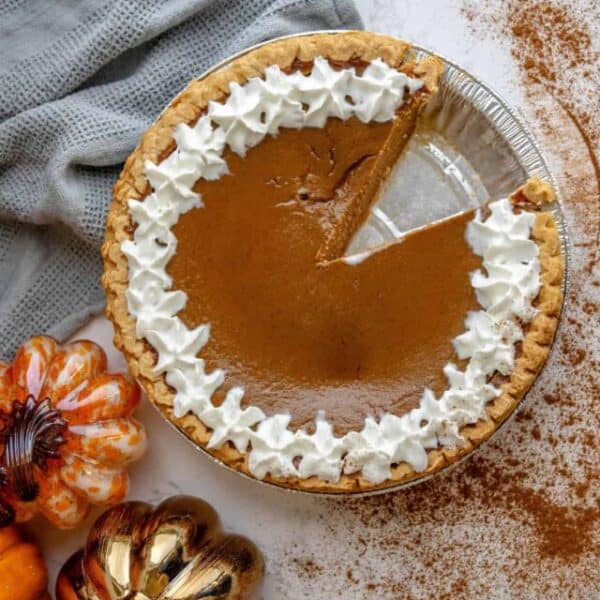 A slice of pumpkin pie with whipped cream.