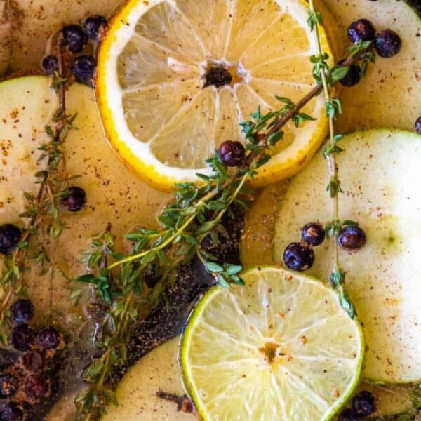Apples, lemons and thyme in a pot.