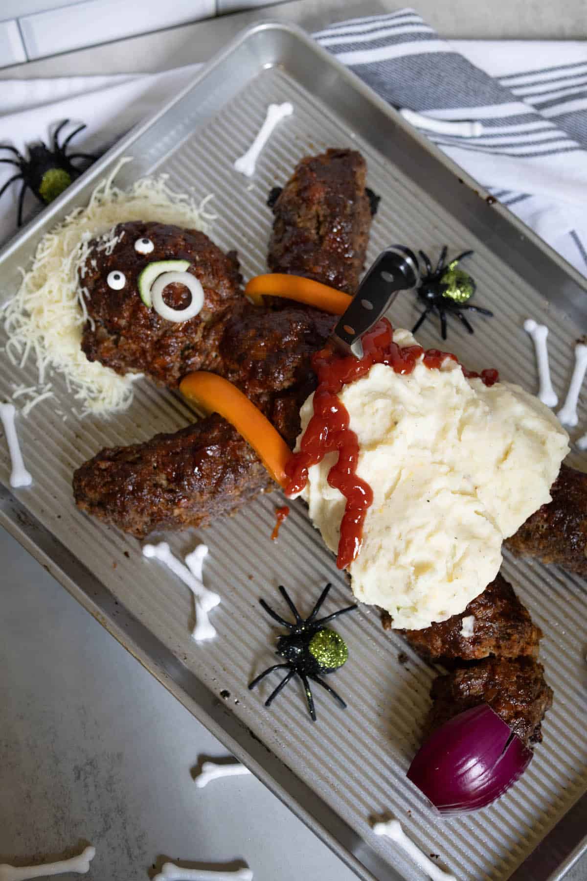 A tray of dead man meatloaf, covered in mashed potatoes and ketchup.