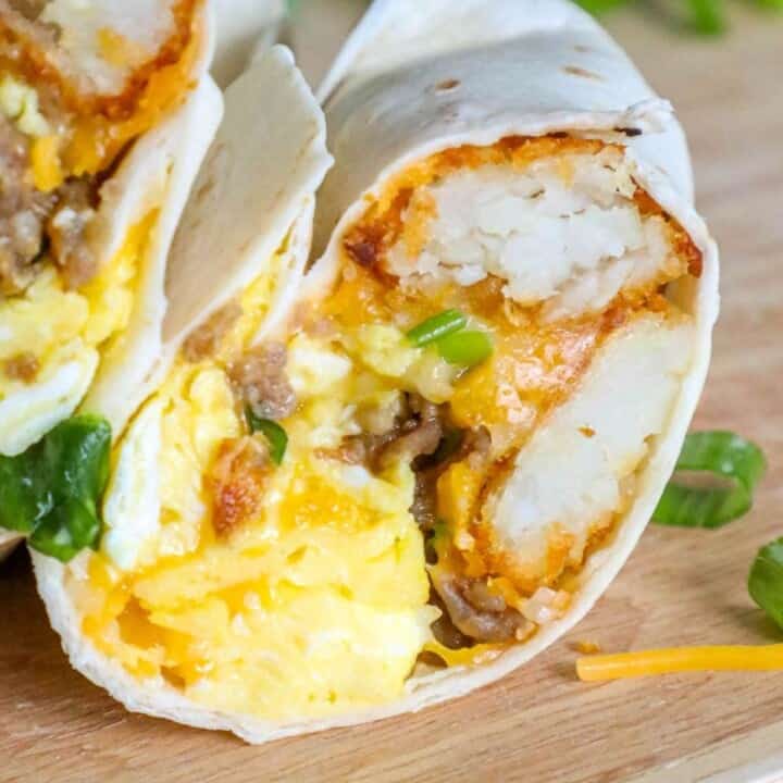 A freezer breakfast burrito with eggs and cheese on a cutting board.