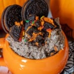 Halloween oreo milkshake in a mug with pumpkins and oreos.