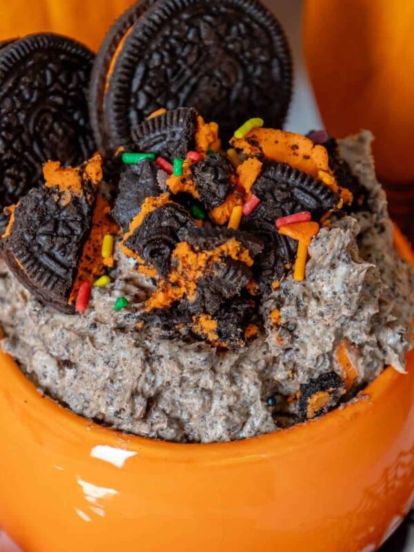 Halloween oreo milkshake in a mug with pumpkins and oreos.